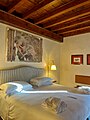 Double Deluxe room in Grand Hotel Villa Arzaga with frescoed walls.