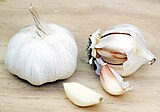 Garlic bulbs and individual cloves, one peeled.