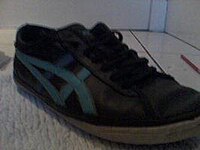 An Asics shoe in boys UK Size 6. This particular style had become a popular choice of school shoe for boys in the United Kingdom at the start of the 2010s