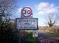 The sign on the road from Napton; note the image of an ichthyosaurus