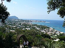 view from hilltop garden across small town to the sea