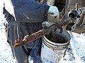 Wax being removed off a wireline wax knife