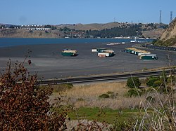 Containers beached on the outskirts of Rodeo with Vallejo and Cal Maritime in the background.