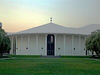 Photo of a circular building surrounded by grass.