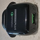 An AC adaptor with a green USB connector supporting Qualcomm Quick Charge 2.0