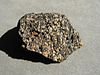 A speckled rock with black and white grains