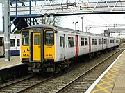 317667 at Cheshunt in plain-white with red doors livery.