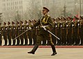 The commander of the honor guard salutes while marching to the saluting base where visiting General Peter Pace will receive the welcoming report.