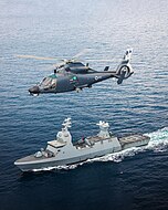 An AS565 Panther Atalef of 193 Squadron is flying above its Sa'ar 6-class corvette in 2024