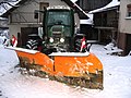 Snowplow attached to an agricultural tractor in Austria