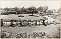 View of the grounds from the back driveway at The Hill, circa 1935. Garden beds enhance the driveway in the foreground.