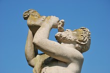 Statue of a man drinking