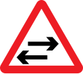 Two-way traffic on cross road ahead warning