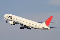 Aircraft takeoff. Side view of twin-engine jet in flight with flaps and landing gear extended, with upswept wings.