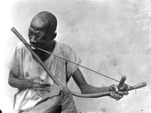 A man playing a musical bow in Nigeria