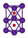 The ball-and-stick diagram shows two regular octahedra which are connected to each other by one face. All nine vertices of the structure are purple spheres representing rubidium, and at the centre of each octahedron is a small red sphere representing oxygen.