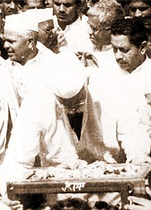 Group of men behind a small table