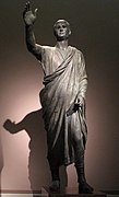 The Orator, c. 100 BC, an Etrusco-Roman bronze statue depicting Aule Metele (Latin: Aulus Metellus), an Etruscan man wearing a Roman toga while engaged in rhetoric; the statue features an inscription in the Etruscan alphabet