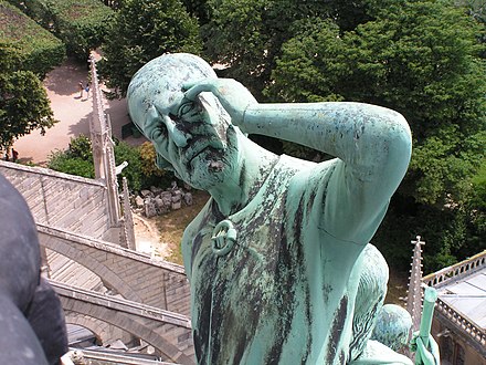 Statue of Thomas the Apostle, with the features of restorer Viollet-le-Duc, at the base of the flèche