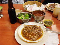 A plate of birria with condiments.