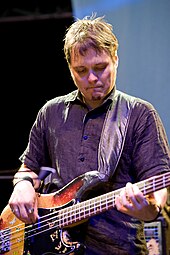 A man playing a bass guitar