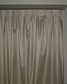 Beige curtain in a home.