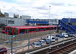 Two B07 rolling stock next to an older B92 rolling stock at the Poplar DLR depot next to Poplar DLR Station.