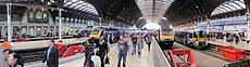 The platforms inside the train shed at London Paddington station. Three of the platforms are occupied by First Great Western High Speed Trains, while another two have Heathrow Express units