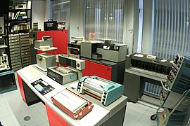 Large IBM 1130 systems still handled paper tape in the early 1970s (at left of console).