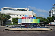 The square's Fire and Water Fountain, behind it the Esther cinema (2012).