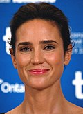 Jennifer Connelly—a white female with straight dark hair pulled back tightly around her head, hazel eyes, and smiling slightly—attending the 2010 Toronto International Film Festival at age 39.