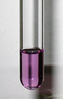 A test tube containing a clear violet solution