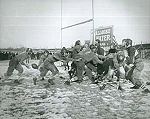 Black and white photo of football players on a field