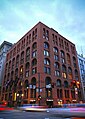 A night shot of the Boston building, which is located in the heart of downtown Denver.