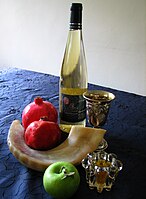 Traditional Rosh Hashanah foods: Apples dipped in honey, pomegranates, wine for kiddush