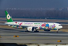 Side view of aircraft in flight; fuselage painted with Sanrio characters' faces.