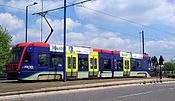 Sideways view of tram 06 in original livery