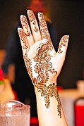 Mehndi is the application of henna as a temporary form of skin decoration, commonly applied during Eid al-Fitr.