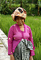 An elderly Sundanese woman wearing kebaya, kain batik and batik headcloth, West Java.