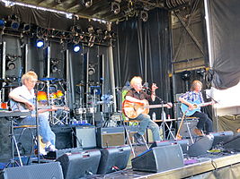 The band seated onstage