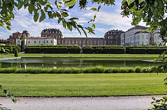 The palace with its gardens. The 17th-century wing on the right (in white plaster) while the 18th century wing is in the center (with a brick exterior).