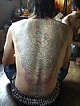 Devotee of Wat Bang Phra covered in Yant Tattoos