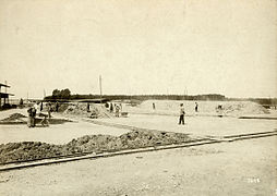 ca. 1900–1910 a drying area: one firing pile is being prepared; another is under way