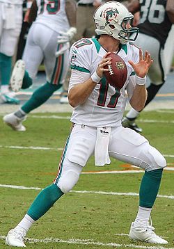 Tannehill, in white Miami Dolphins uniform, steps back into the pocket before throwing in 2013.