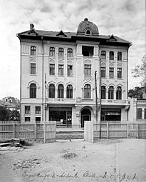 Black-and-white photo from circa 1925 of the Primary Teachers House of Ploiești, by Toma T. Socolescu, with a tiled roof