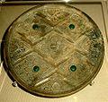 A late Zhou Dynasty or early Han Dynasty (c. 300–200 BCE) Chinese bronze mirror inlaid with glass and showing influence from Hellenistic civilization in Central Asia