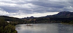 Carmacks as seen from the Yukon River bridge with the river in the foreground.