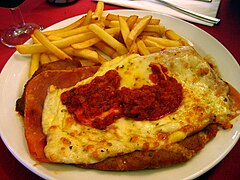 Milanesa a la napolitana con papas fritas.