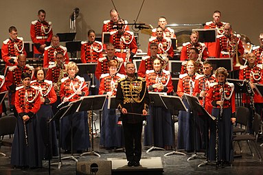 Colonel Colburn stands with the Marine Band after completing Sergei Rachmaninoff's Symphonic Dances during the Marine Band's performance at the East Carolina University in Greenville, North Carolina, 2011.