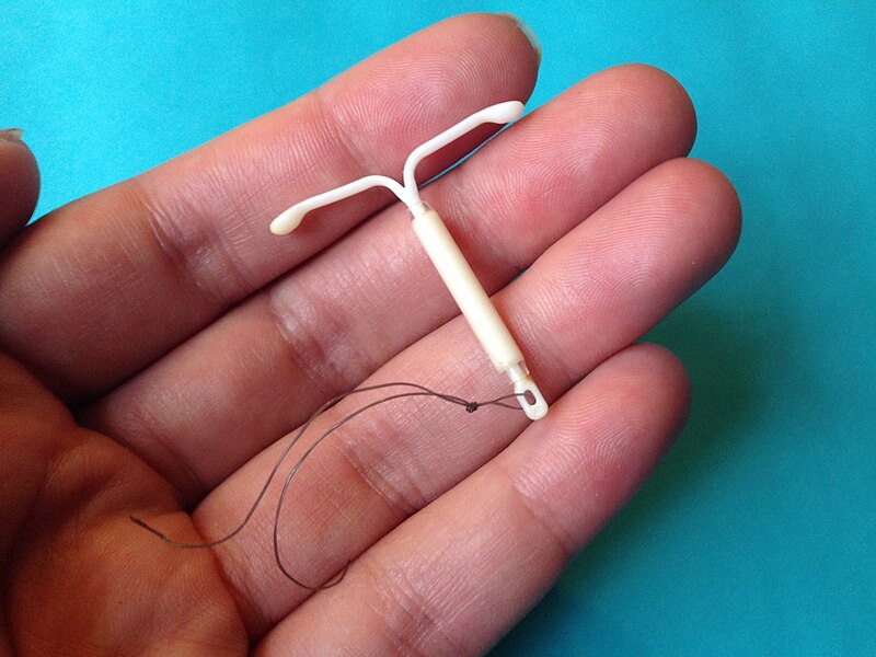 File:Mirena IUD with hand.jpg